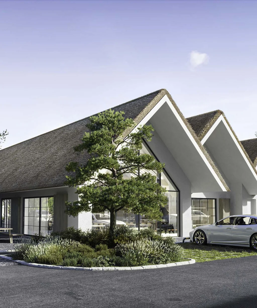 Modernes Gebäude mit markanten dreieckigen Dächern und geparkten Autos